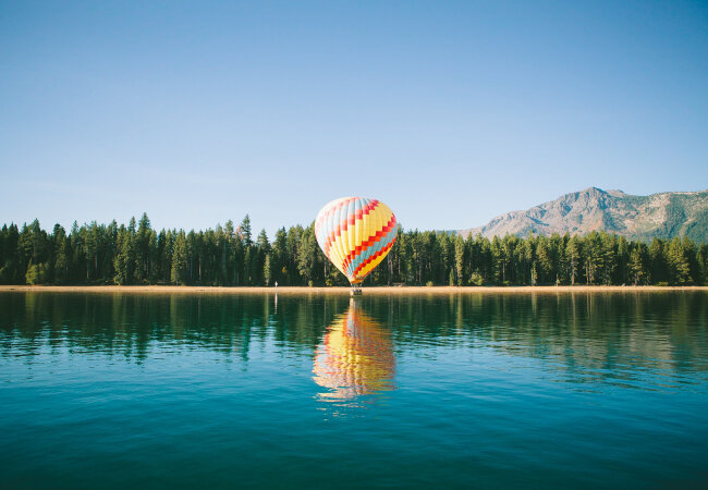 A lake with a hot air balloon